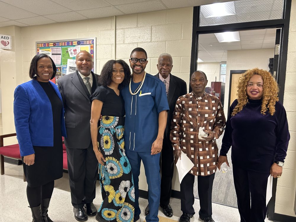 A group of faculty and students smile at an event.